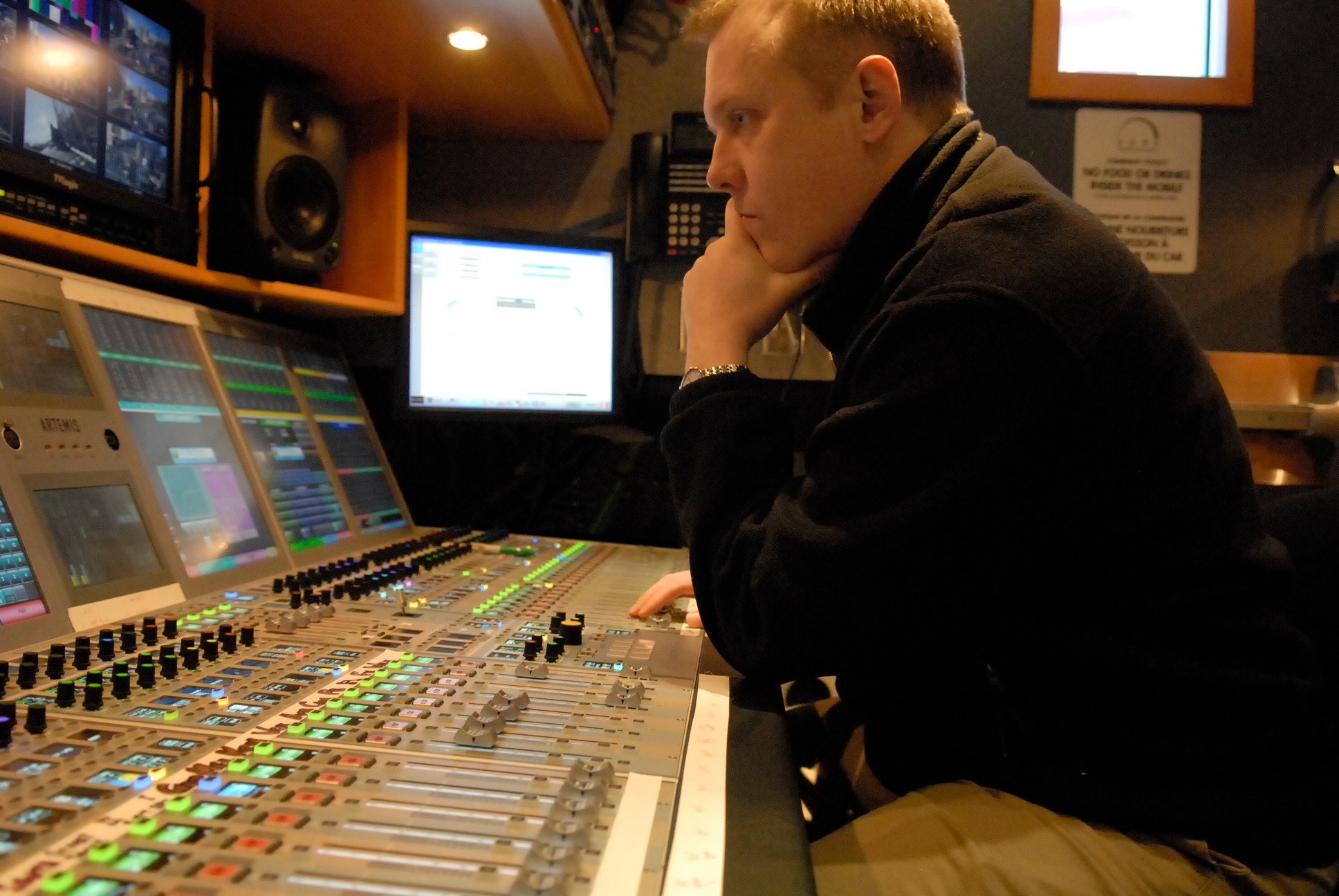 Michael Nunan mixing on a Calrec Artemis console inside a Dome Productions OB mobile truck